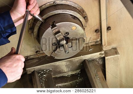 The Worker Installs A New Metal Part In The Chuck Spindles For Processing On The Cnc Machine. Hands 