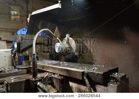 The Worker In Blue Workwear, The Operator Of The Cnc Machine, Oversees The Process And Controls It. 