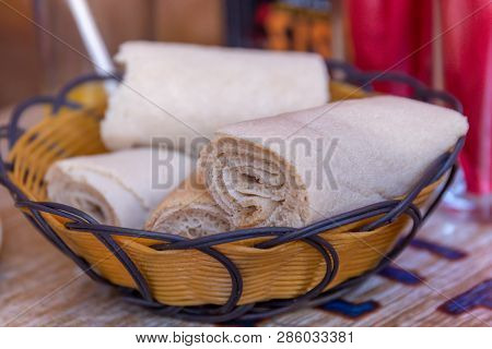 Rolls Of Injera In A Serving Bowl.  Injera Is A Sourdough Flatbread Made From Teff Flour.  It Is The