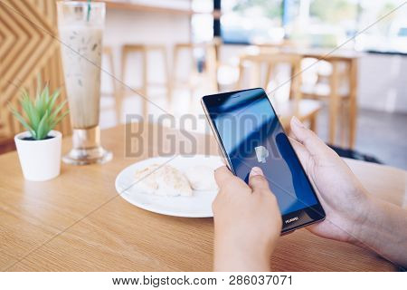 Chiang Mai, Thailand - Jan. 19,2019: Woman Holding Huawei With Paypal Apps On The Screen. Paypal Is 