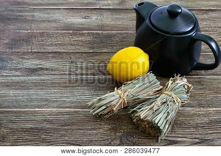 Organic Dry Lemongrass (cymbopogon Flexuosus) In Bunches And Lemon Fruit On A Wooden Table. Herbs Fo