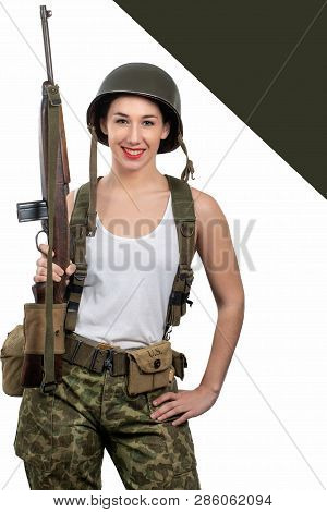 Pretty Young Woman Dressed In Wwii Military Uniform With A Helmet And Rifle