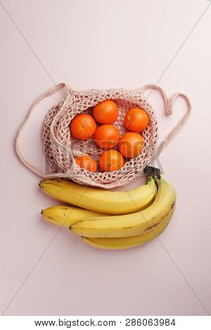 Fruits Tangerine, Banana In Recycling Net Market Bag On White Background. String Mesh Bag, Minial Co
