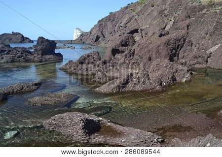 The Beach Of Porto Corallo In Background Pan Di Zucchero
