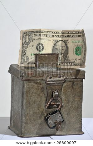 old steel money box with padlock and dollar