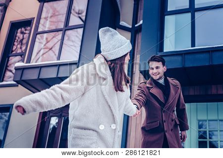 Handsome Husband Looking At His Positive Good-looking Wife