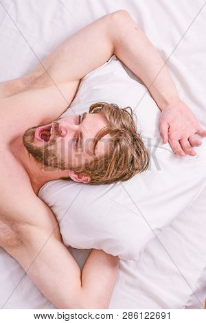 Man Handsome Guy Lay In Bed. Get Adequate And Consistent Amount Of Sleep Every Night. Expert Tips On