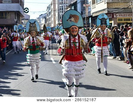 Verin, Spain, 24 Feb 2019. Famous Carnival And Street Parade With Cigarrons Costumes. Ourense Provin