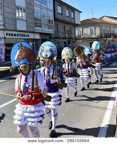 Verin, Spain, 24 Feb 2019. Famous Carnival And Street Parade With Cigarrons Costumes. Ourense Provin