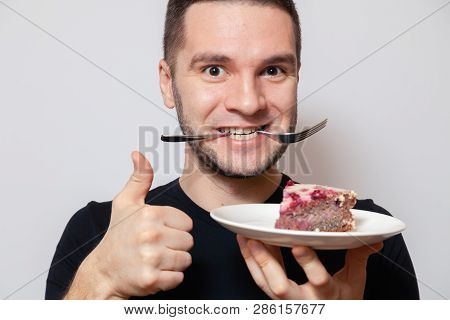 Closeup Portrait Young Cute Caucasian Man Smile, Show Thumbs Up, Hold Fork In Teeth And White Round