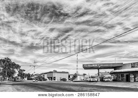 Carnavon, South Africa, August 31, 2018: A Street Scene, With Vehicles, People And Businesses, In Ca