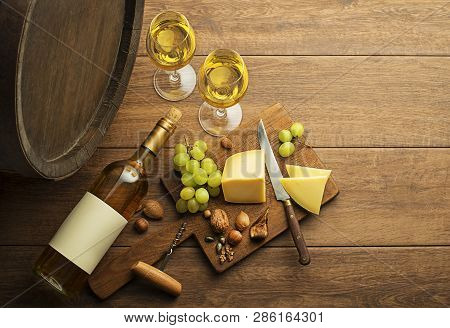 Bottle Of White Wine With Snack Food On Old Board And Barrel. Wine Bottle Mockup.
