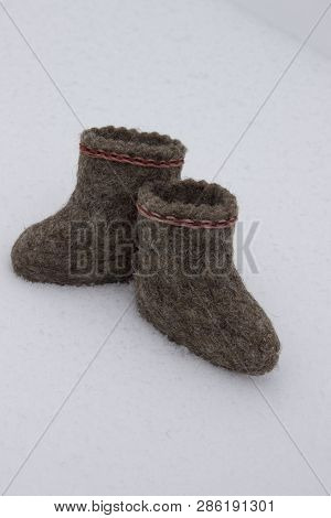 A Pair Of Russian Felt Boots Standing On White Snow In Winter Close-up