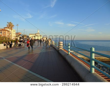 Genova, Italy - 02/14/2019: An Amazing Caption Of The Sunset Over The Sea And The City Of Genoa In W
