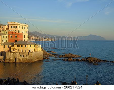 Genova, Italy - 02/14/2019: An Amazing Caption Of The Sunset Over The Sea And The City Of Genoa In W