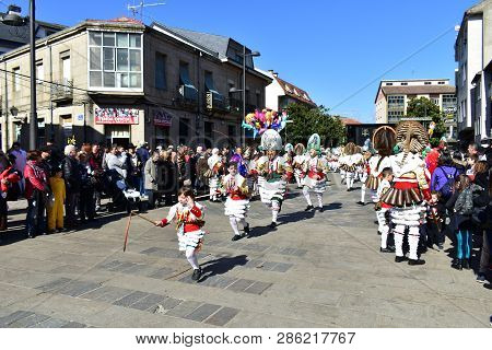 Verin, Spain, 24 Feb 2019. Famous Carnival And Street Parade With Cigarrons Costumes. Ourense Provin