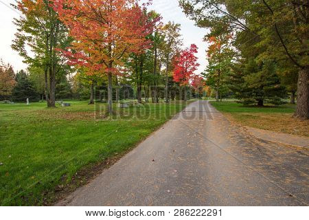 Autumn Camping. Empty Campground Surrounded By Lush Foliage And Many Available Sites On A Warm Autum
