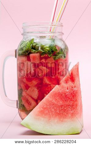 Watermelon Smoothie With Slice Of Fruit And Leaf Of Mint Over Pink Background, Copy Space, Close Up