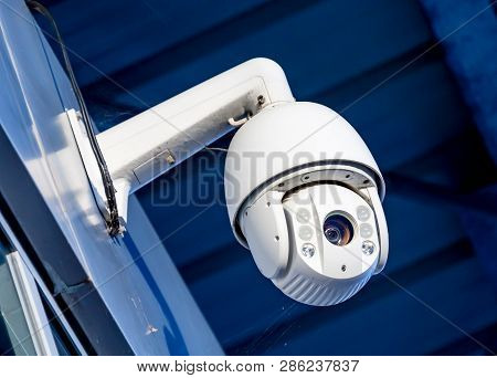 Close-up Of Modern Cctv Camera On The Wall Of An Industrial Building