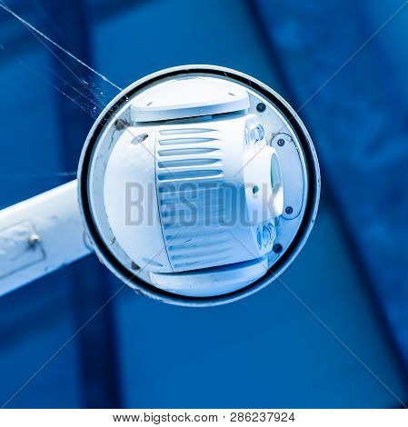 Close-up Of Modern Cctv Camera On The Wall Of An Industrial Building