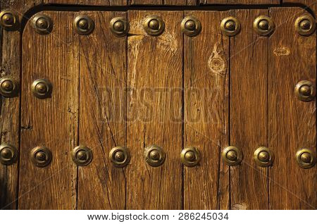 Bronze Studs Attached To Wooden Planks At Caceres