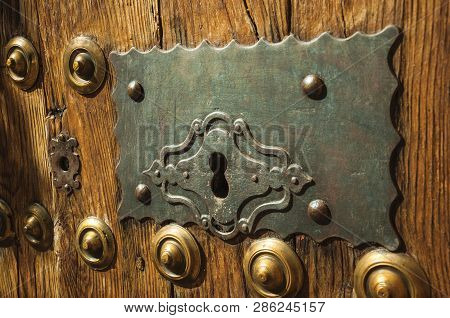 Bronze Studs And Wrought Iron Keyhole In An Old Door At Caceres