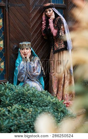 Beautiful Azeri Women In Traditional Azerbaijani Dress Knocking The Wooden Door