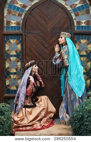 Beautiful Azeri Women In Traditional Azerbaijani Dress Knocking The Wooden Door