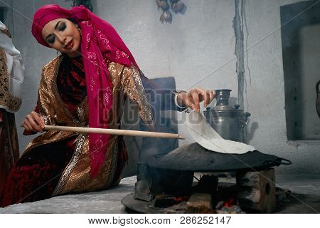 Woman Preparing Or Making Borek Or Bread Dough On Fire