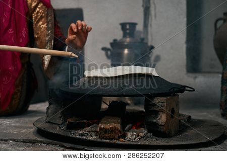 Woman Preparing Or Making Borek Or Bread Dough On Fire