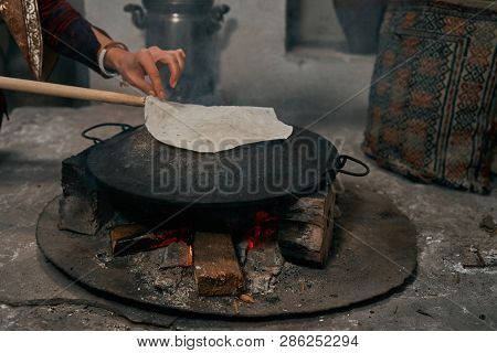 Woman Preparing Or Making Borek Or Bread Dough On Fire