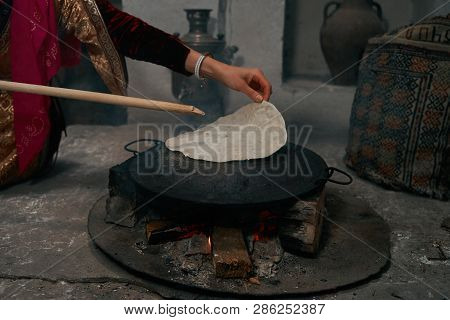 Woman Preparing Or Making Borek Or Bread Dough On Fire