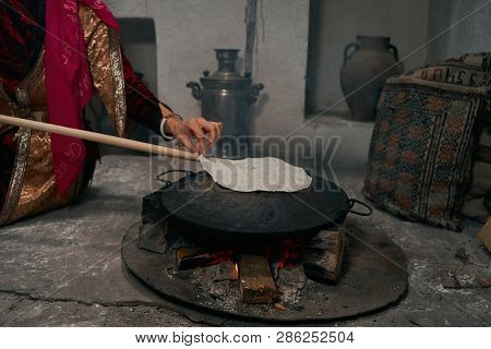 Woman Preparing Or Making Borek Or Bread Dough On Fire