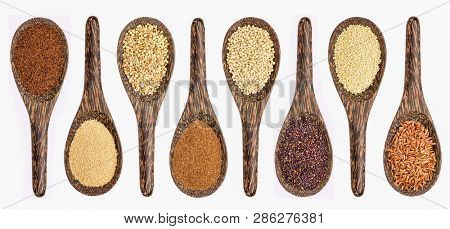 variety of gluten free grains (from left: kaniwa,  amaranth,  buckwheat, teff, sorghum, black quinoa,  millet, and brown rice) - set of wooden spoons isolated on white