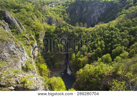 Unesco World Heritage Site Skocjanske Jame. Looking Towards The Deep Gorge With Cave Entrance And Wa