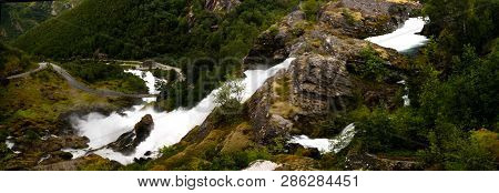 Panoramic View To Kleivafossen Waterfall On Briksdalselva River, Briksdalsbreen Glacier, Norway