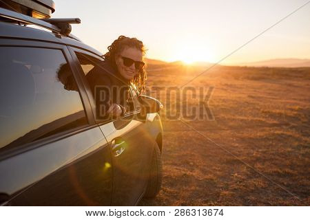 Woman on the road trip, sunset in Cabo de Gata-Nijar Natural Park, Andalusia, Spain