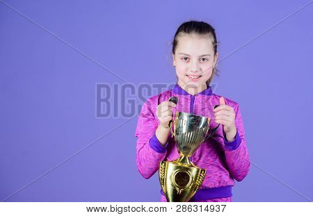 She Is The Best. Small Girl Holding Silver Cup. Little Child With Cup Shaped Sports Trophy. Cute Ath
