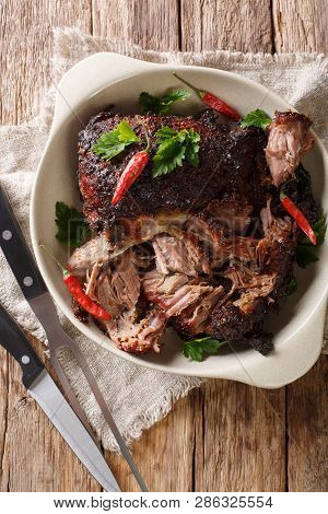 Delicious Spicy Slow Shredded Pulled Pork Closeup On A Plate. Vertical Top View