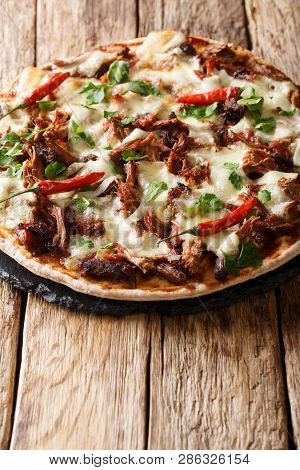 Spicy Pulled Pork Pizza With Mozzarella Cheese, Herbs And Barbecue Sauce Close-up. Vertical