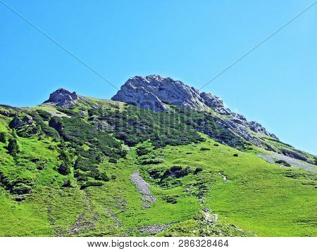 Mountain Hikers On The Alpine Peak Of Margelchopf And In The Alviergruppe Mountain Range - Canton Of