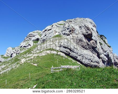 Mountain Hikers On The Alpine Peak Of Margelchopf And In The Alviergruppe Mountain Range - Canton Of