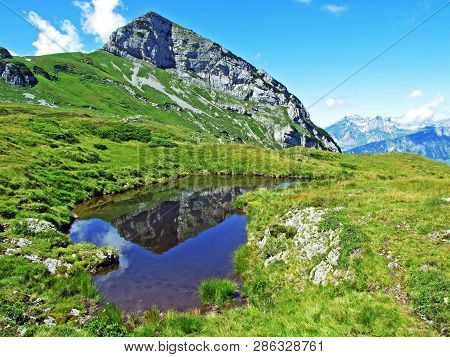 Mountain Hikers On The Alpine Peak Of Margelchopf And In The Alviergruppe Mountain Range - Canton Of