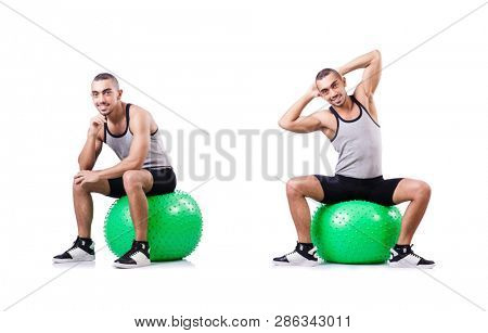 Man with swiss ball doing exercises on white