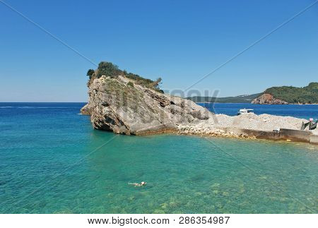 Rocks And Boat On Island Of St. Nicholas In Budva, Montenegro. Paradise Beach On Island In Sea. Conc