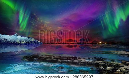 Beautiful northern lights of the northern part of the planet. Magnificent views of the ocean and northern lights with rocks and stones. Beautiful sea water plays with colors and light