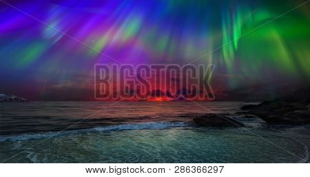 Beautiful northern lights of the northern part of the planet. Magnificent views of the ocean and northern lights with rocks and stones. Beautiful sea water plays with colors and light