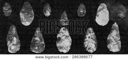 Flint instruments from the ancient diluvial age of St Acheul valley of the Somme, vintage photo. From the Universe and Humanity, 1910.
