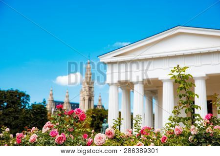 Vienna, Austria - Tourists Visiting The Theseus Temple In Volksgarten Park With The City Hall At The