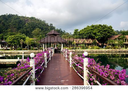 Wooden Platform Leading To A Bungalow On The Shores Of The South China Sea, Decorated With Flowers A